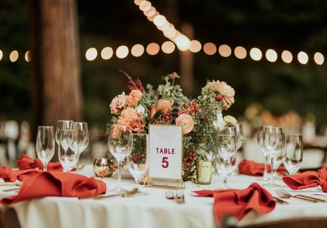 peach, red , and gold wedding centerpiece in the forest at waterfall lodge in ben lomond, ca