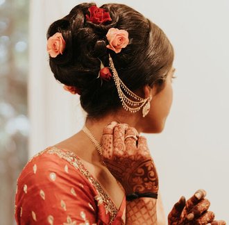 Put flowers in your hair on wedding day for a beautiful way to accent your wedding day hair. don't forget your indian jewelry