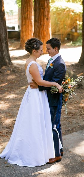 Bride and Groom giggling under the redwood trees at The Harvest Inn in Napa County. Photo credit: Maria Villano, Floral: Beijaflor Botanicals, hair and makeup: Contour Bridal